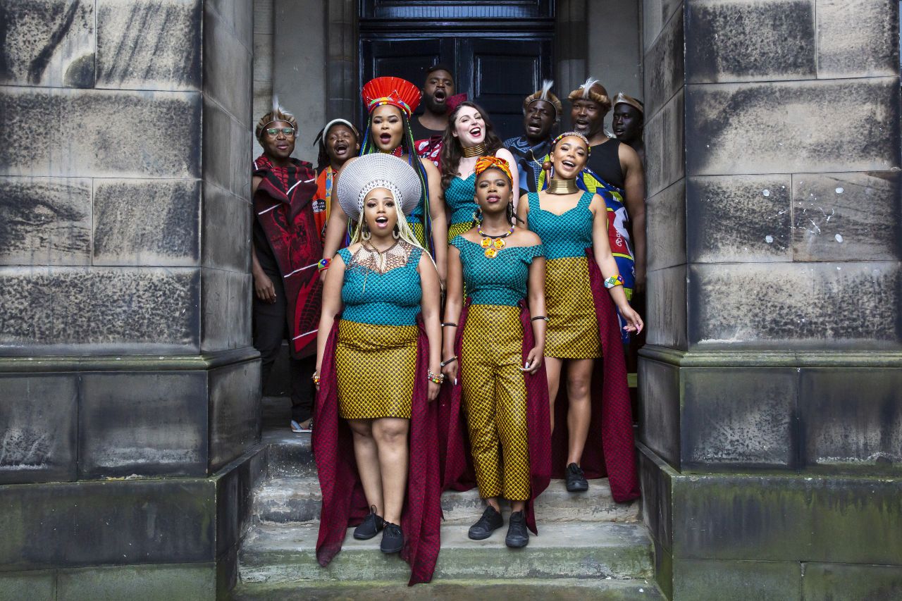Members of Shona the Musical Choir in the surroundings of the Old College Quad, the location of one of the Festival's outdoor venues. Shona the Musical Choir features in the Edinburgh International Festival’s music line-up at Edinburgh Park on 16 August. More information at [eif.co.uk](https://www.eif.co.uk).  Photo: Jess Shurte