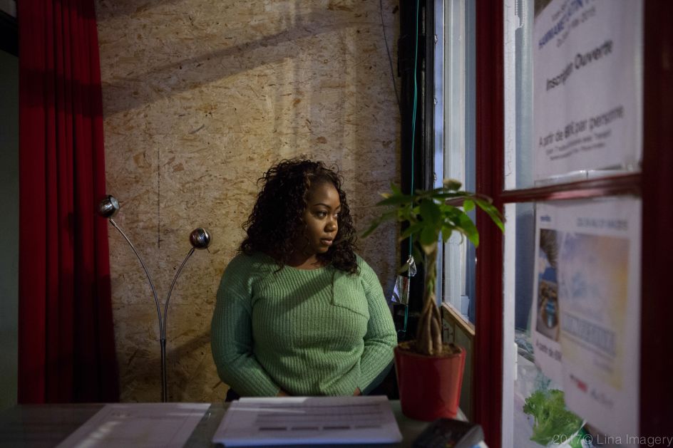 Linda Corinne Soul, stares at the window in the dance school she works as a hostess in Paris From the series ‘First Generation’ © Carolina Arantes