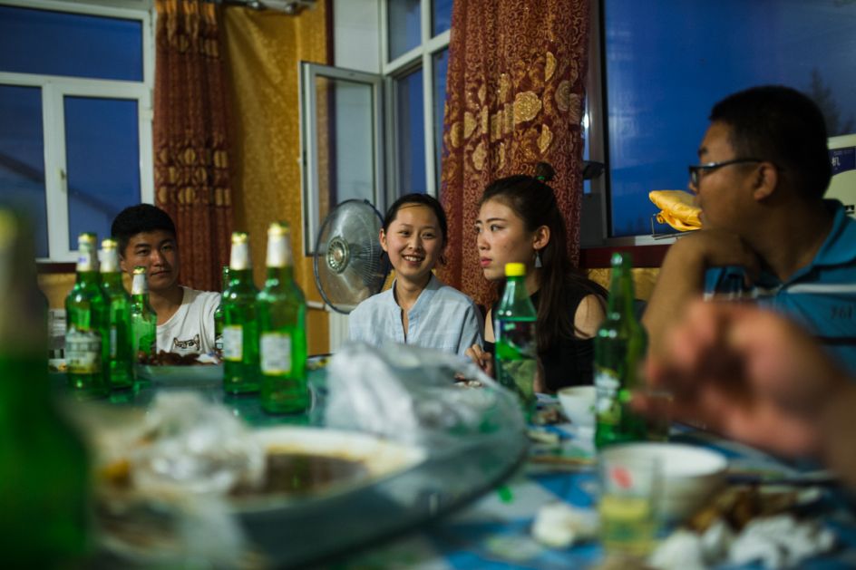 Xin'e Oroqen Settlement, August 2017  Oroqen youth and their friends from other ethnic groups – Mongolian, Han, Daur and Ewenki, eat together during a summer break. Life for these young people is dramatically different to that of the generations preceding them and many now attend universities across China or follow their parent into roles within local government.