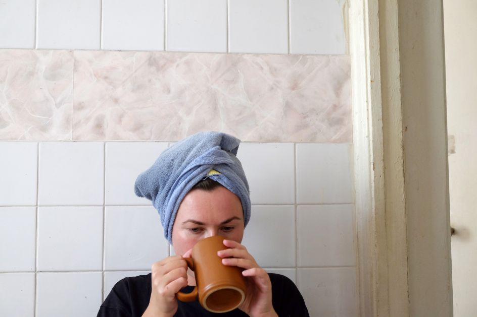 Self-portrait, drinking tea in the kitchen, commonness, equilibrium point, summer 2017. Copyright: © Maria Petrenko, Ukraine, Shortlist, Professional, Discovery (Professional competition), 2018 Sony World Photography Awards