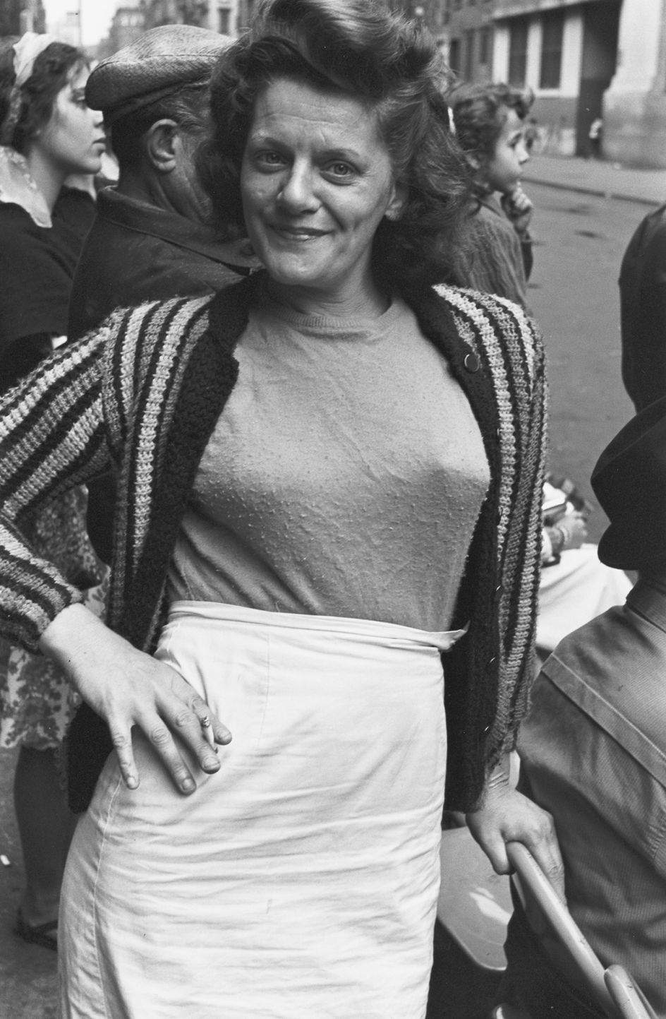 Woman with her hand on her hip, holding a cigarette, 1963