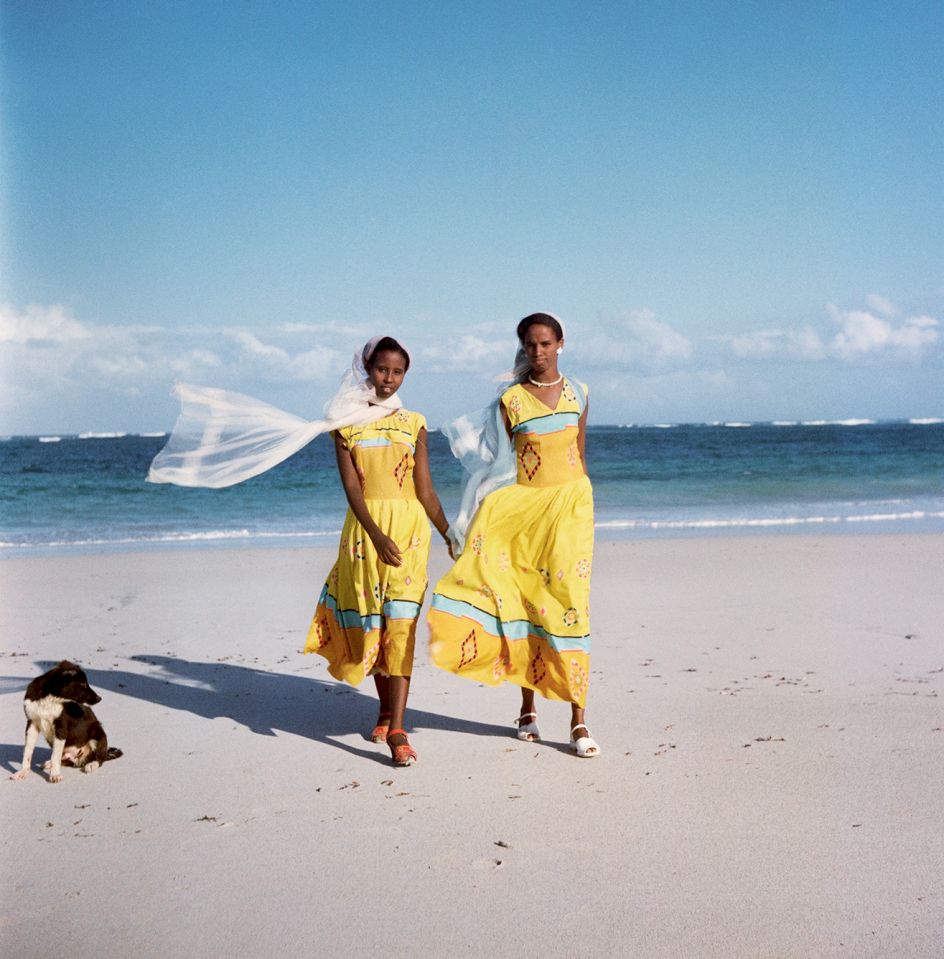 Trust Territory of Somaliland (Somalia), 1958 – Two women walking on the beach, with a dog to their right © 2021 Todd Webb Archive