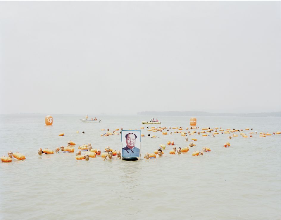 People crossing the river with a photo of Mao Zedong, Henan, 2012 © Zhang Kechun