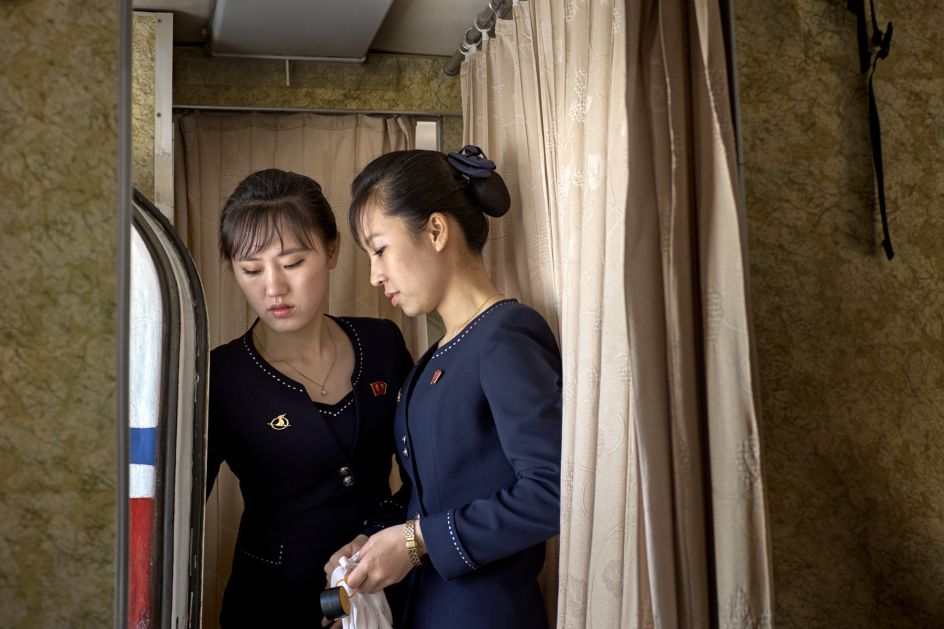 A senior stewardess explaining the door-handling