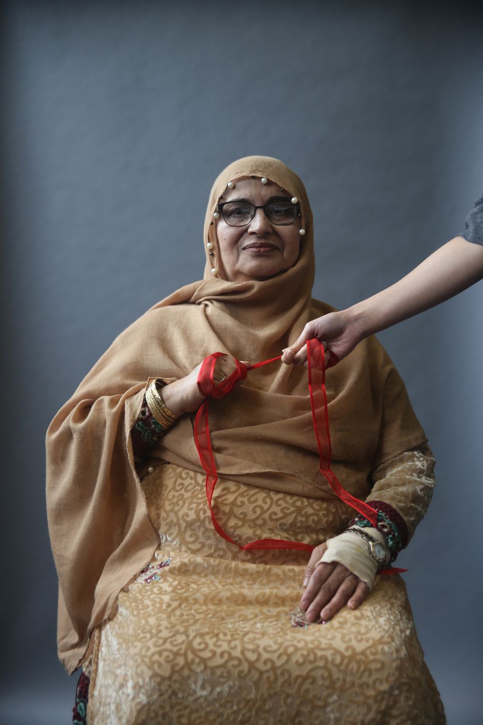Zahida Qateel Glasgow, 2018 Scarlett Crawford, 2018.  “Zahida wanted to communicate her pride in family and community. She asked her daughter to hold the ribbon with her to represent this.” © UK Parliament