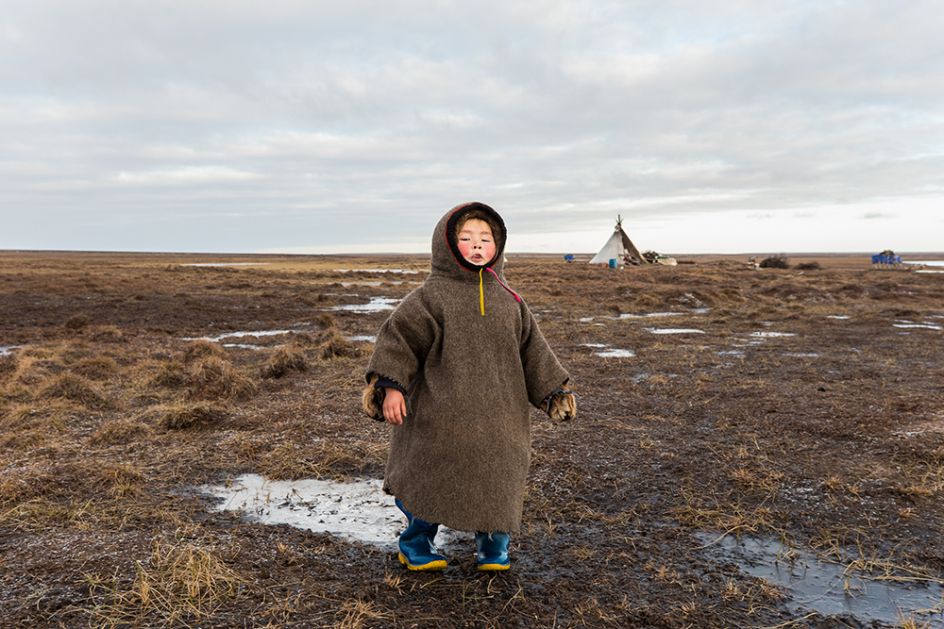 For the four-year-old Christina the vast open landscape of the tundra in autumn is her playground, and she makes a game of breaking the thin ice that forms over the pools of water. Gradually as the winter comes, the air becomes crisper and temperatures begin to drop consistently. The layers of ice begin to thicken and Christina finds great joy in rolling on the thick frozen ice. Image credit: Alegra Ally/Schilt Publishing