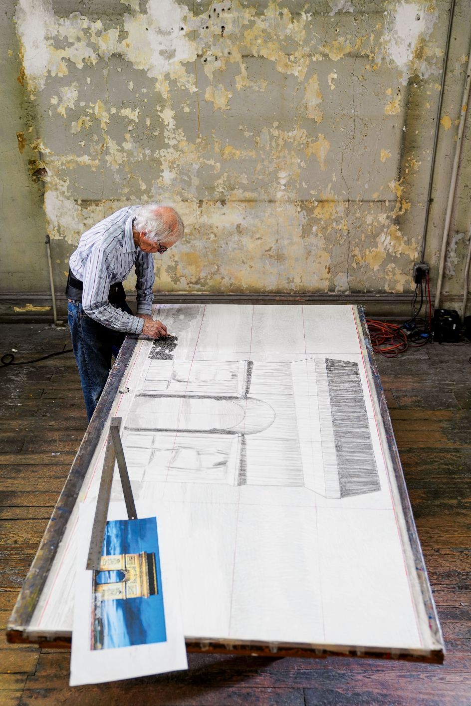January 2020, New York City, Christo in his studio, working on a large preparatory drawing for the Arc de Triomphe, Wrapped Photo: © Wolfgang Volz