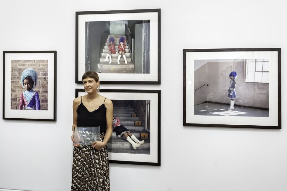 First prize winner, Alice Mann, with her portraits. Photograph by Jorge Herrera.