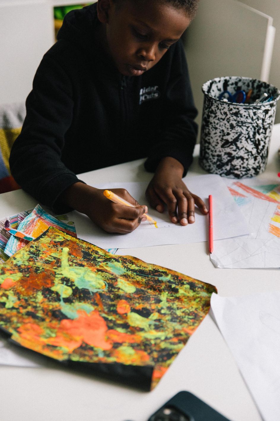 Lakwena's son Makelo drawing at home