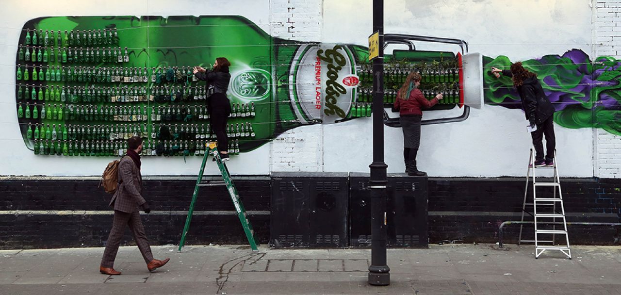 400 green bottles hanging on the wall create a giant tribute to 400