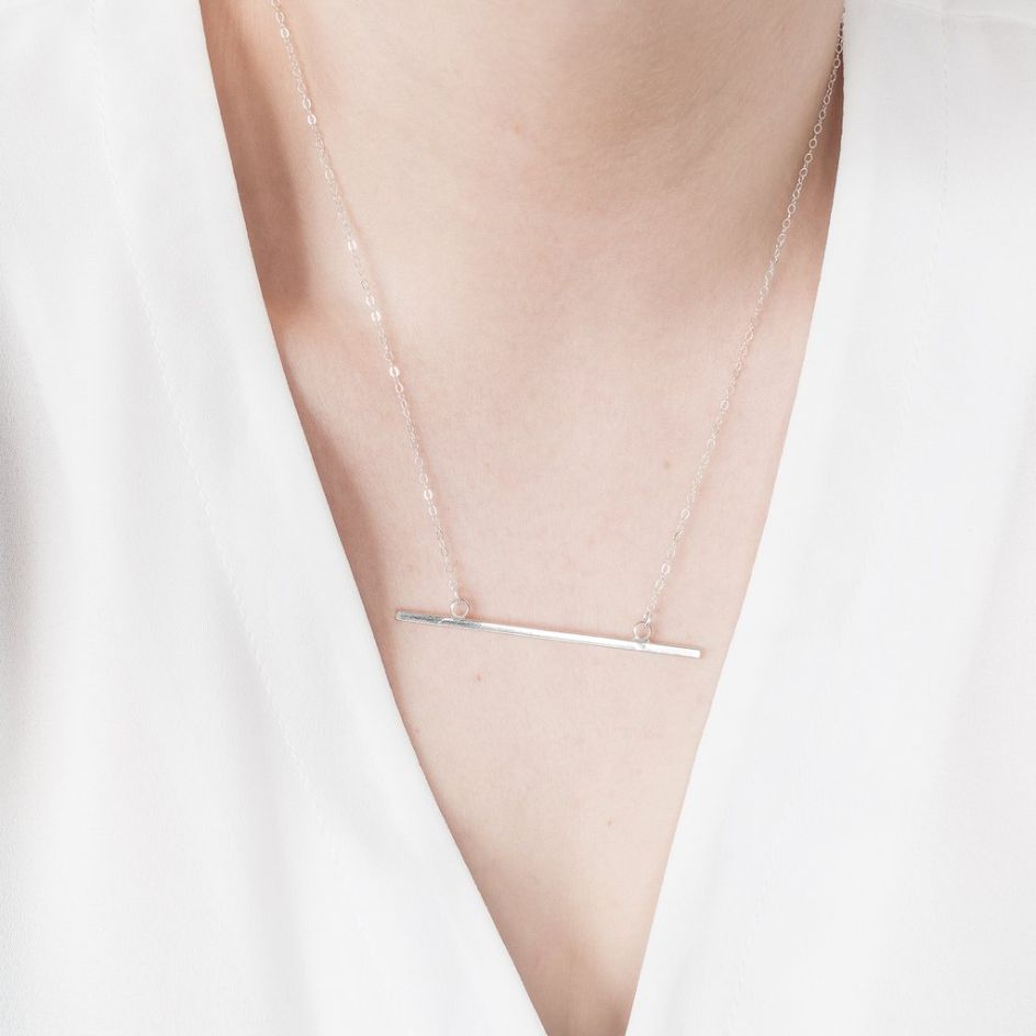 Minimal Bar necklace by [OMCH](https://www.ohmyclumsyheart.com/collections/necklaces/products/sterling-silver-horizontal-bar-necklace). Priced at £27