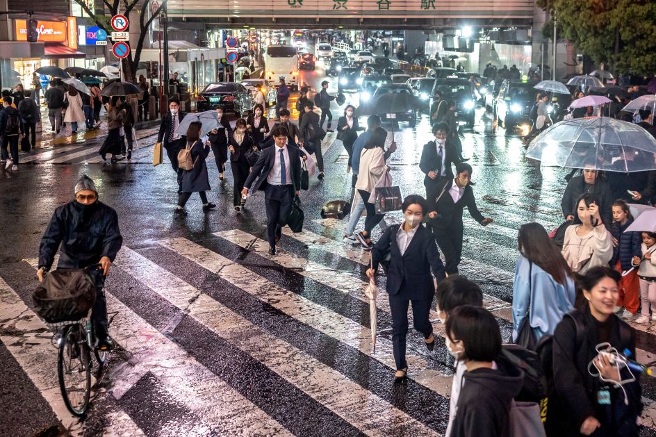 The famous Shibuya Scramble Crossing located in front of the Shibuya Station. Stopping vehicles in all directions to allow pedestrians to inundate the entire intersection. Shibuya City, Tokyo