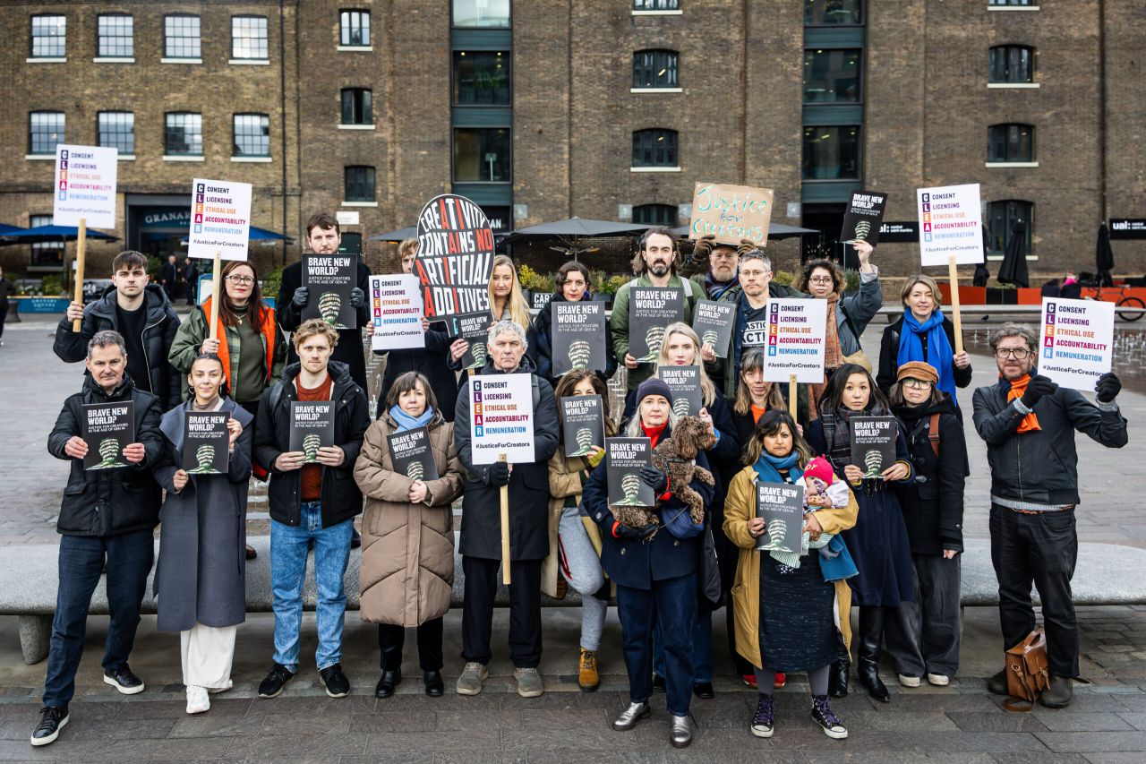 Creators taking a stand in Granary Square, King’s Cross. Including illustrators Benji Davies, Chris Haughton, Ged Adamson, Momoko Abe and Simona Ciraolo, and AOI Board Member Jhinuk Sarkar. Photograph by Ozzy Nada.