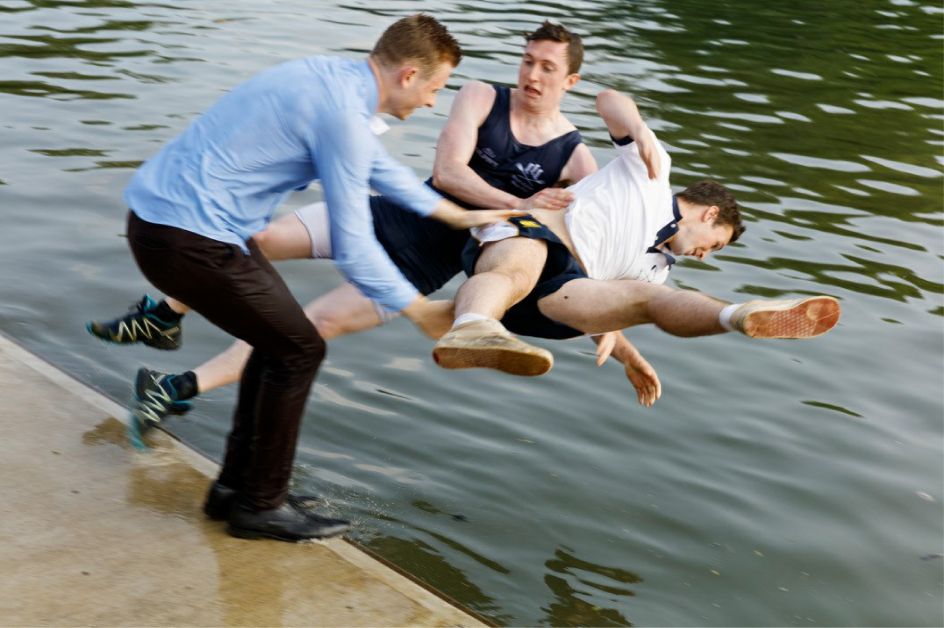 After the Summer Eights competition the winning team and often other college rowers are thrown into the river. Oriel College rowers, 2016 © Martin Parr / Magnum Photos / Blindspot Gallery