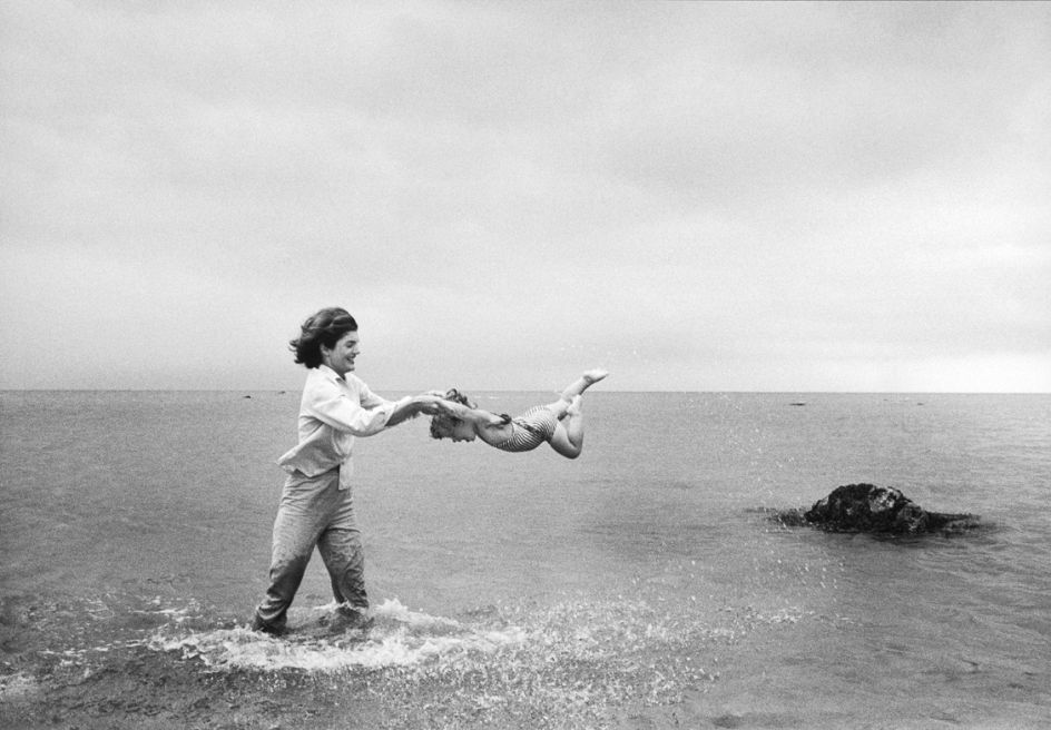 Jackie swings Caroline in the shallows at Hyannis Port, 1959 © Mark Shaw / mptvimages.com
