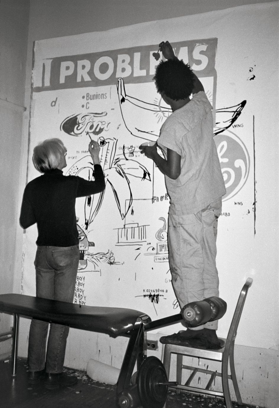 Andy and Jean Michel painting Problems at Andy’s studio at 860 Broadway, March 27, 1984. Copyright: © The Andy Warhol Foundation for the Visual Arts, Inc.