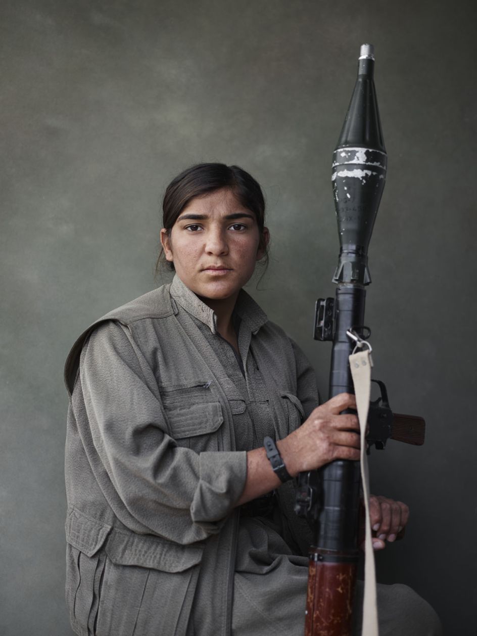 Portrait of Sarya with rocket-propelled grenade launcher. Makhmur, Erbil Governorate, Iraq, March 4, 2015. From [We Came From Fire​](​https://amzn.to/2L9l8Vm) by Joey L. – published by powerHouse Books