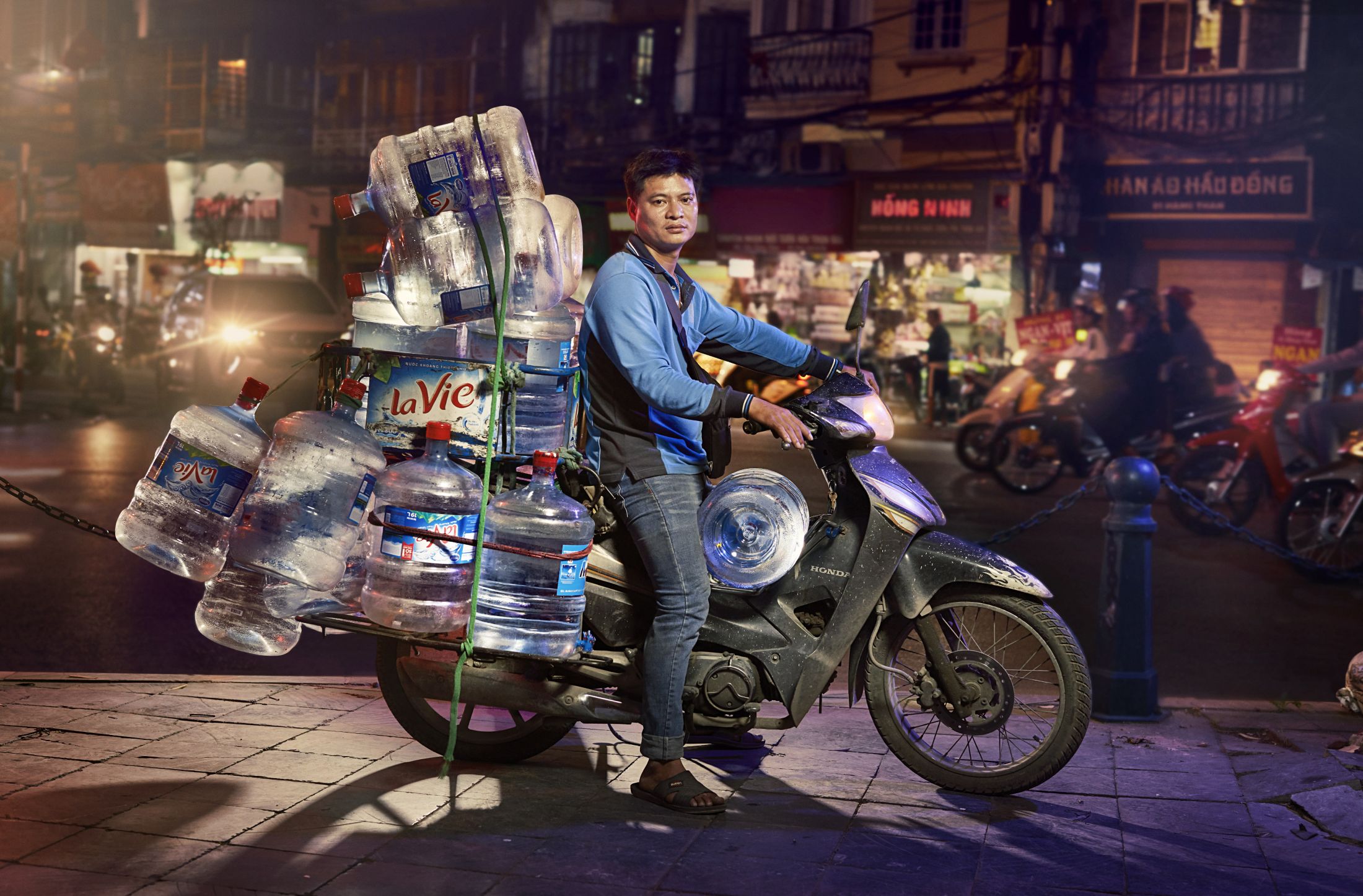 Traveler riding a moped in a Southeast Asian city