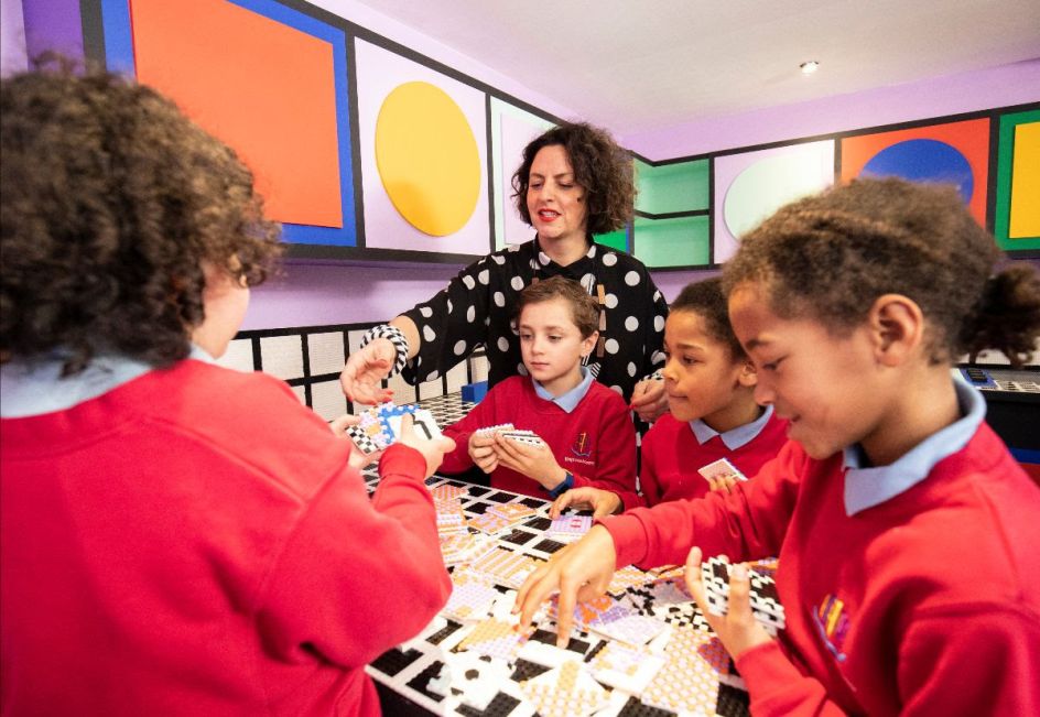 Workshop with kids at Camille Walala's new installation for LEGO, celebrating the launch of DOTS. ​Photo credit Getty Images.