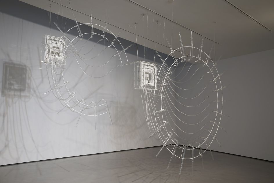 Installation shot of Cerith Wyn Evans in The Hepworth Prize for Sculpture. 26 October 2018 - 20 January 2019. Photo, Stuart Whipps Composition for 37 flutes (in two parts), 2018, 37 crystal glass flutes, ‘breathing’ unit and valve system, plastic tubes.