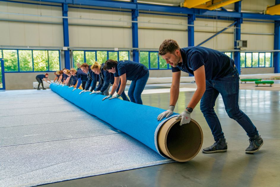 Felix Dickenberger, Ingrid Moller, Mary Timm, Sascha Donitzky, Margareta Eisenreich, Irina Laas, and Lydia Miklucha roll the sewn panels onto tubes. They purposely roll the fabric so that the silvery side is inside and ready to be unfurled on the Arc de Triomphe.The largest panels will be 8 meters (26 feet 4 inches) wide, weighing one metric ton (1.1 ton) each.