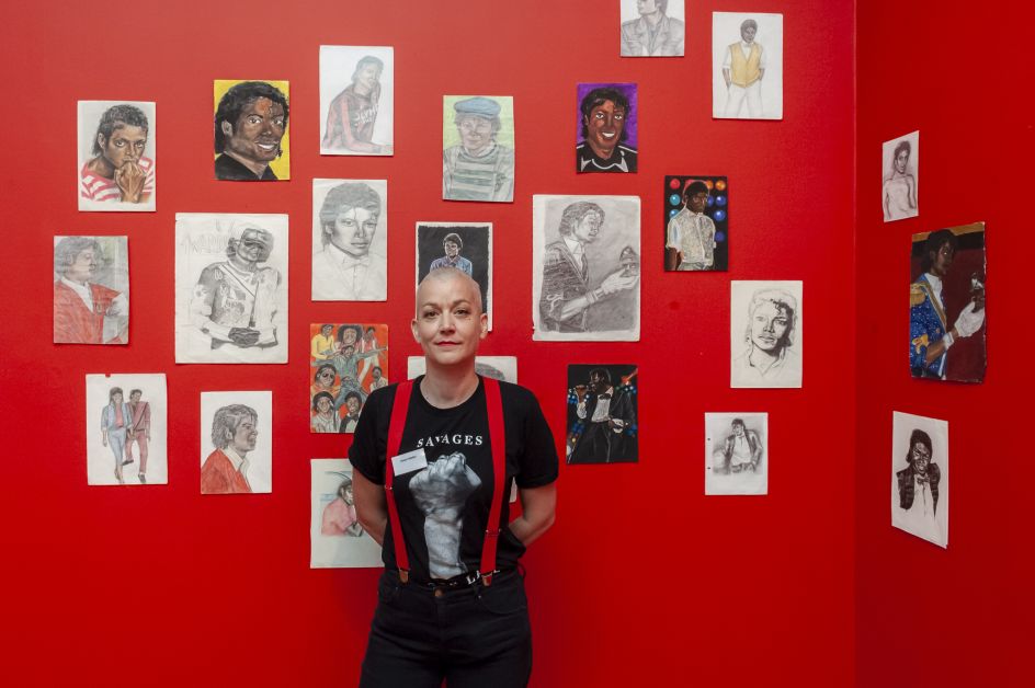 Dawn Mellor with her work, Drawings of Michael Jackson 1984-6. Photograph by Jorge Herrera