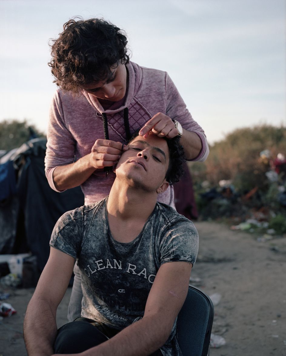 Calais, France, November 2015 North African men threading their eyebrows.