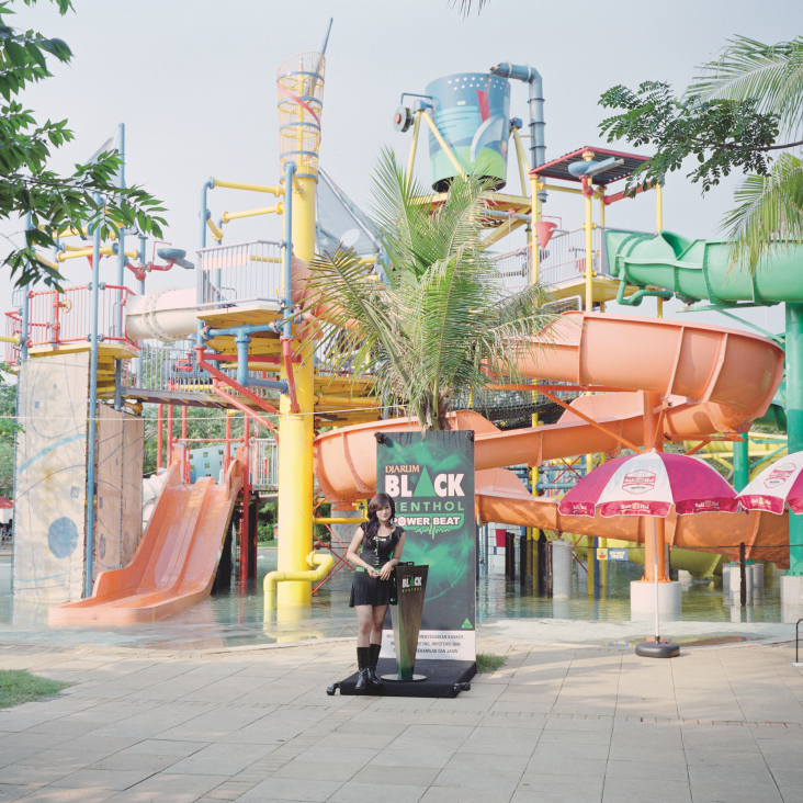 All images © Rocco Rorandelli and courtesy of GOST Books. Jakarta, Indonesia A salesperson promoting Djarum Black Menthol cigarettes during a music parade, organised by Djarum, inside a waterpark.