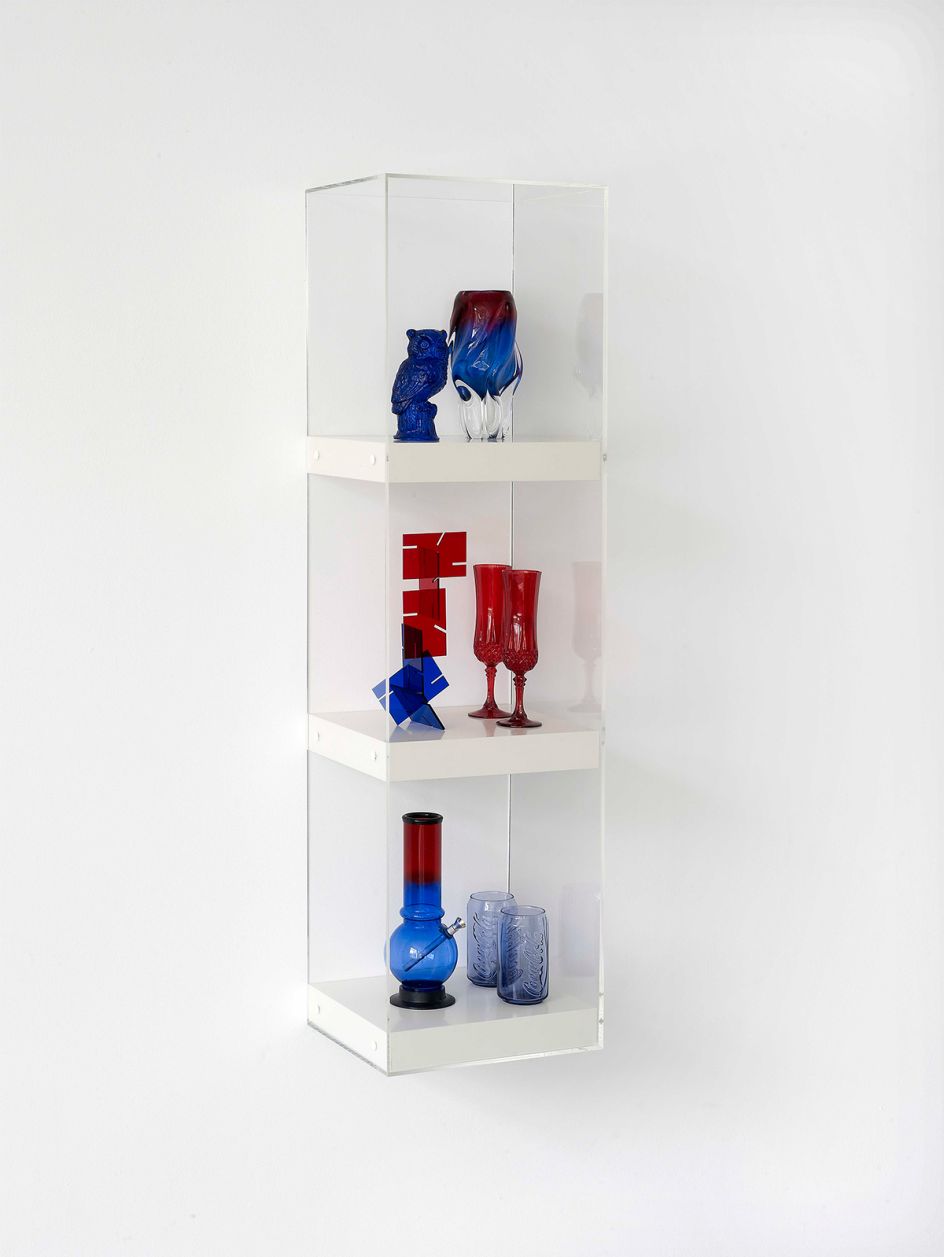 Matthew Darbyshire Untitled: Shelves No. 7 (Series 2) 2010 Resin cast owl figurine, Murano vase, acrylic desk sculpture, crystal d’arque champagne flutes, acrylic bong, McDonald’s Coca Cola glasses, shelves, Perspex case 120 × 30 × 30 cm Courtesy of the artist and Herald St, London