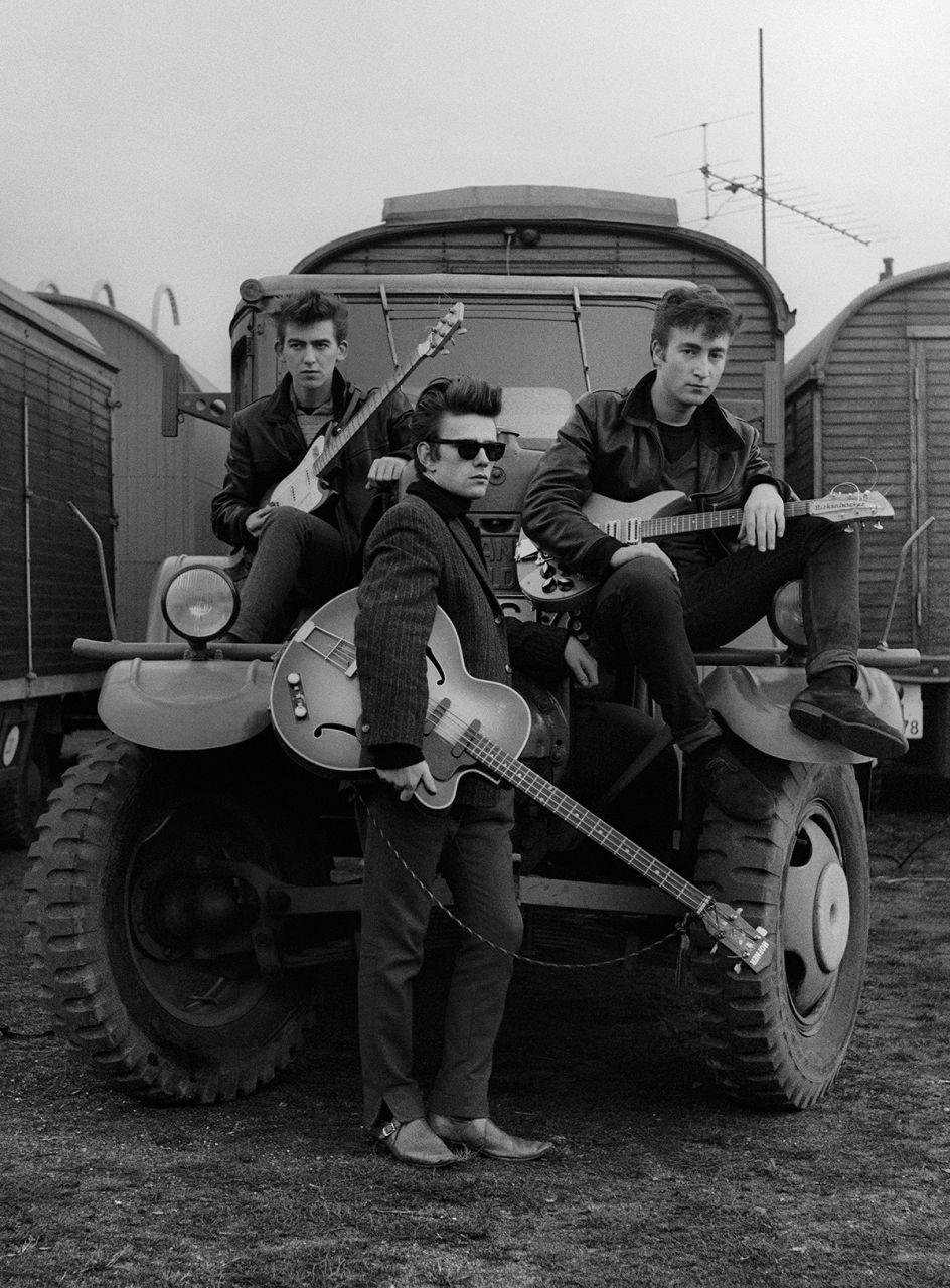 Astrid Kirchherr,  John Lennon, Stuart Sutcliffe and George Harrison  on a truck at the fairground, 1960