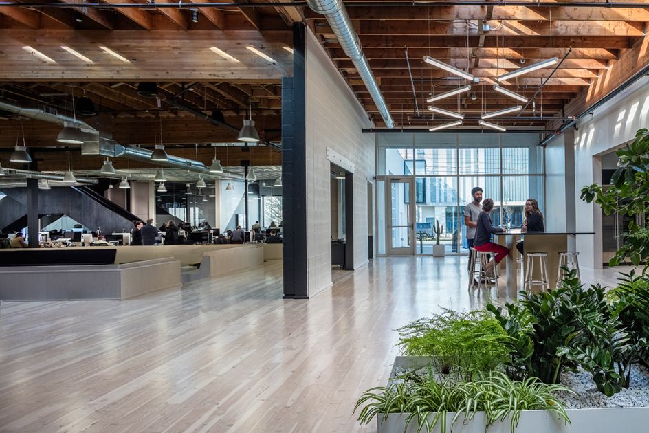 Swift Kitchen/Creative Quad: The north entrance opens onto the kitchen and  creative team workspace. A crisscross staircase leads to meeting rooms on  the mezzanine.