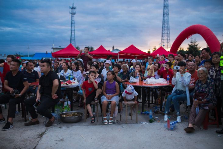 Xin'e Oroqen Settlement, August 2017 A crowd gathers to watch the annual Fire Festival in Xin'e, Heilongjiang Province.