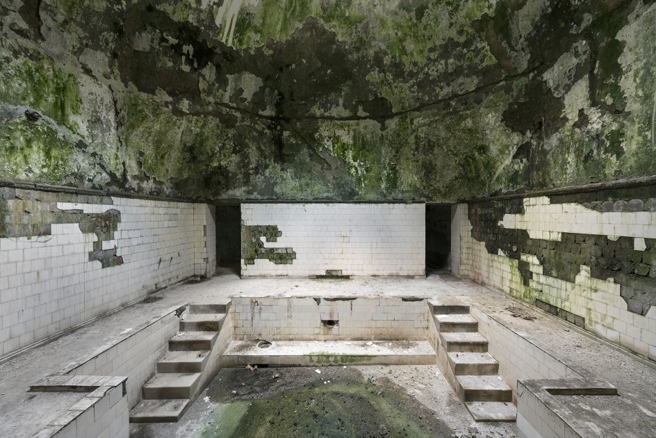 A derelict bathhouse is seen inside the thermal spa town of Tskaltubo. The water still flows through and underneath these baths, causing the buildings to deteriorate even faster. Tskaltubo, Georgia. © Reginald Van de Velde