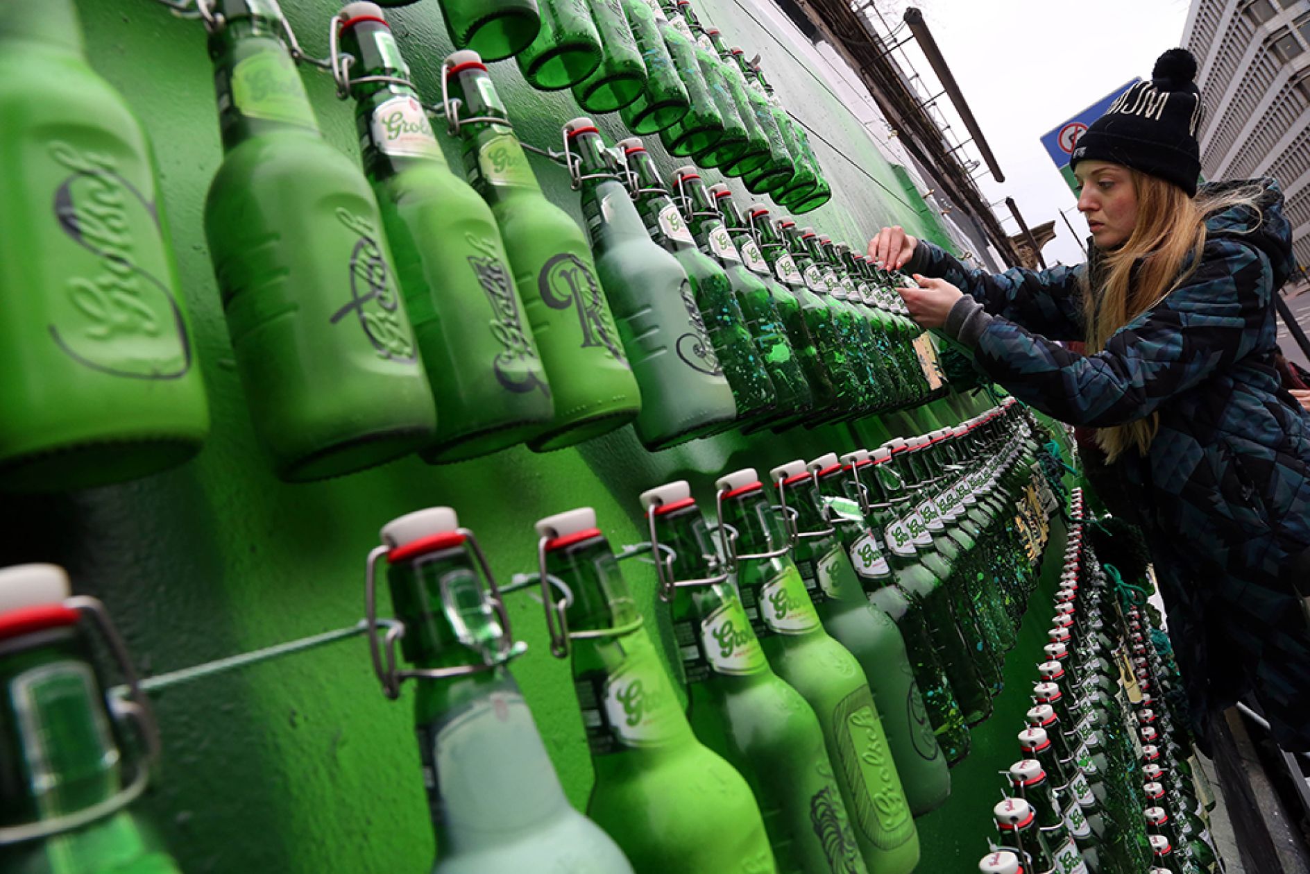 400 green bottles hanging on the wall create a giant tribute to 400 years of beer Creative Boom