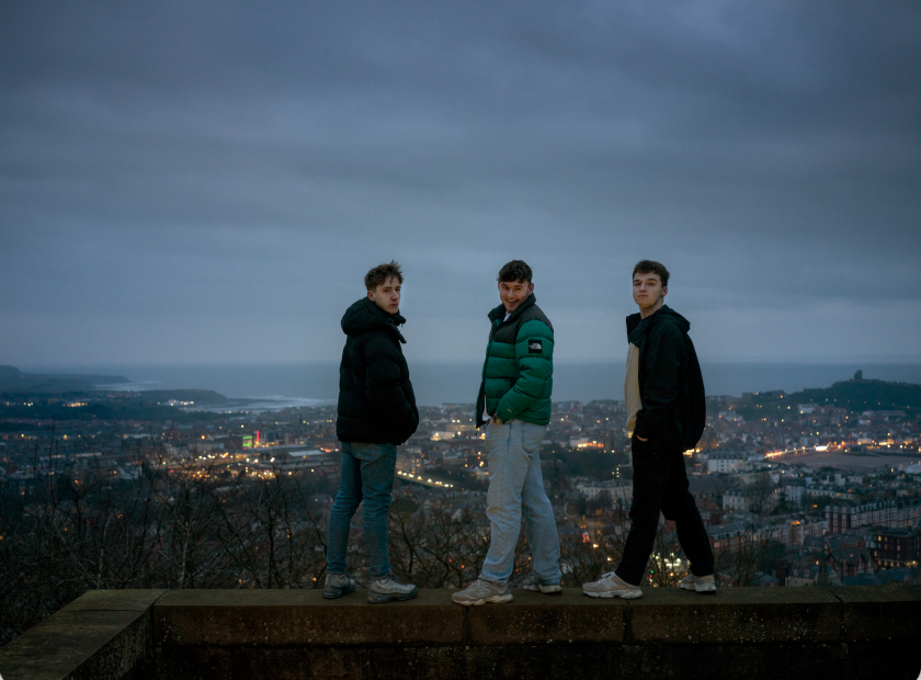 Charlie, 17, and Keane, 19, both from Eastfield, and Jack, 17, from Scarborough, pictured at Oliver's Mount, overlooking Scarborough. Keane wrote a play as a ‘love letter’ to his home town. Against the Tide, 2026. Photograph by Polly Braden