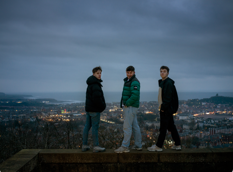 Charlie, 17, and Keane, 19, both from Eastfield, and Jack, 17, from Scarborough, pictured at Oliver's Mount, overlooking Scarborough. Keane wrote a play as a ‘love letter’ to his home town. Against the Tide, 2026. Photograph by Polly Braden