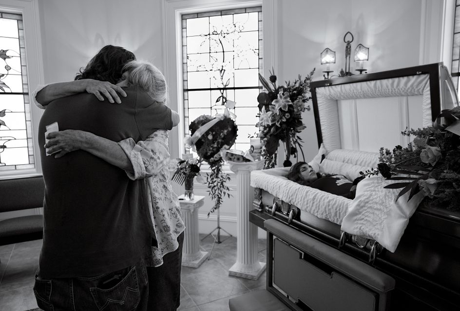 Cheryl Schmidtchen, 67, being consoled at the funeral for her granddaughter Michaela Gingras in Manchester, N.H., on September 17th, 2017. Gingras, a heroin user, was 24. Photograph by James Nachtwey for TIME