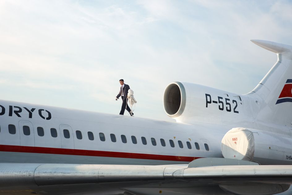 A Pilot removes the engine covers of a Tupolev-154 before flight