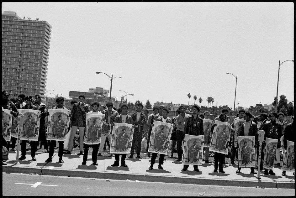 Black Panthers with posters of Black Panther Party Minister of Defense, Huey P. Newton rally outside the Alameda County Courthouse, Oakland CA, during Newton’s trial September 1968. From, “The Lost Negatives,” photographs by Jeffrey Henson Scales. Credit: Jeffrey Henson Scales