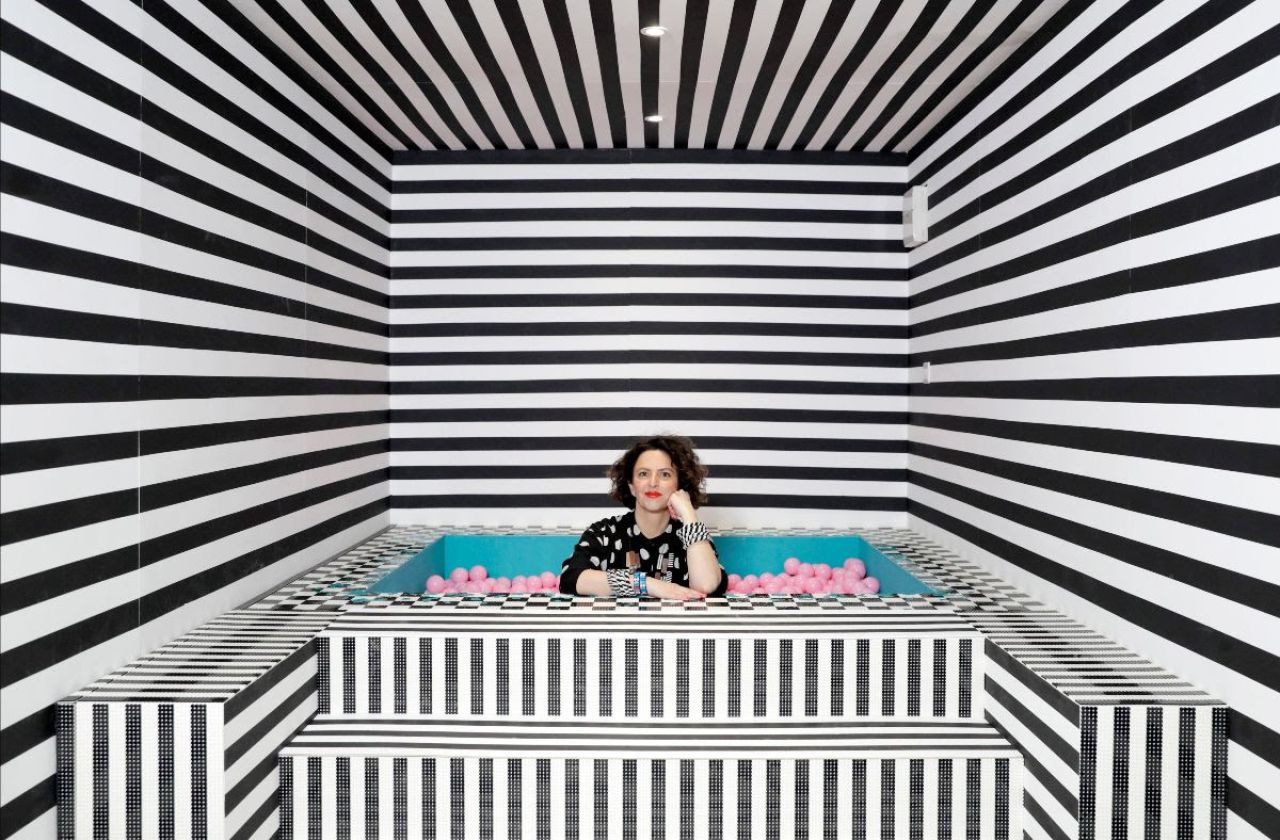 Camille Walala in the ballpit of her HOUSE OF DOTS installation for LEGO. Photo credit Getty Images.