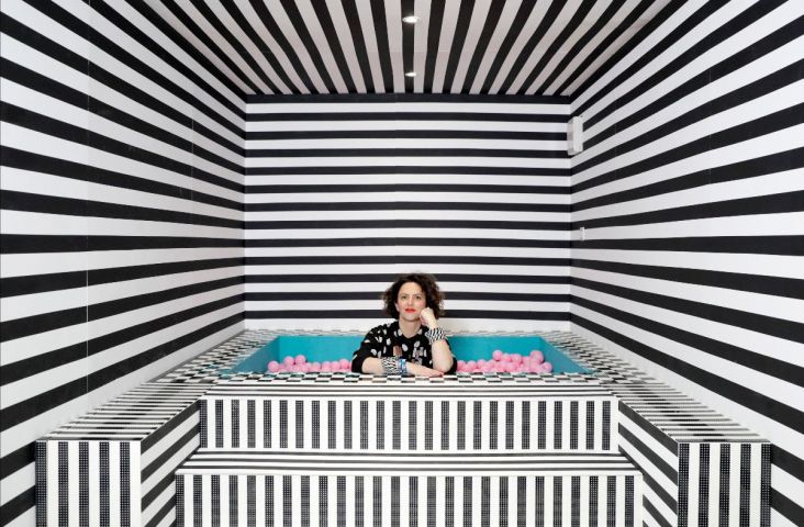 Camille Walala in the ballpit of her HOUSE OF DOTS installation for LEGO. Photo credit Getty Images.