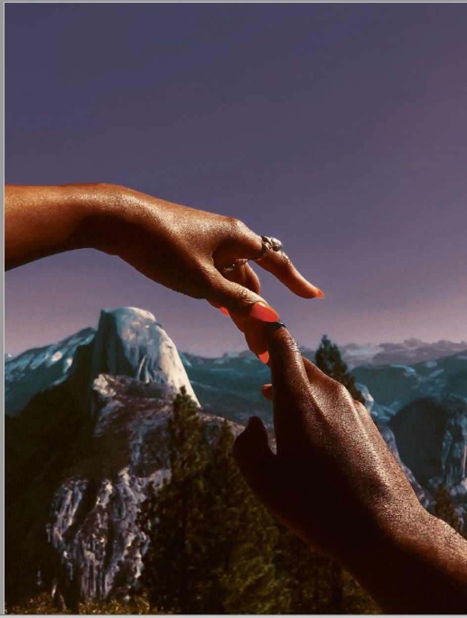 Adrienne Raquel's image image in The Black Vanguard, ModernM, shows two disembodied hands touching, one with long red fingernails, the other less defined and partly in deep shadow.