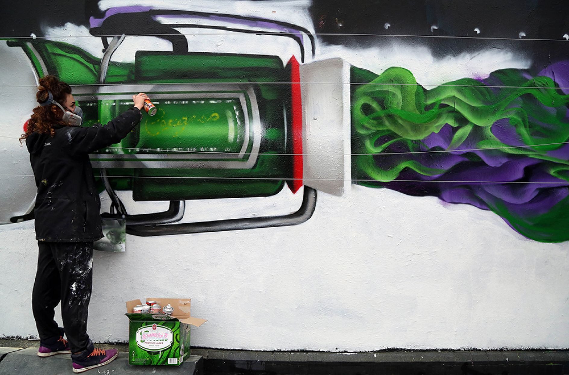 400 green bottles hanging on the wall create a giant tribute to 400