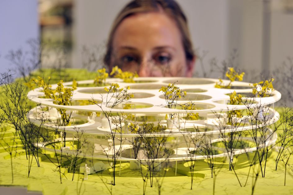 A member of staff at Japan House London inspects House in Catalonia, one of 100 exhibits on display in the inaugural exhibition, Futures of the Future by acclaimed Japanese architect Sou Fujimoto
