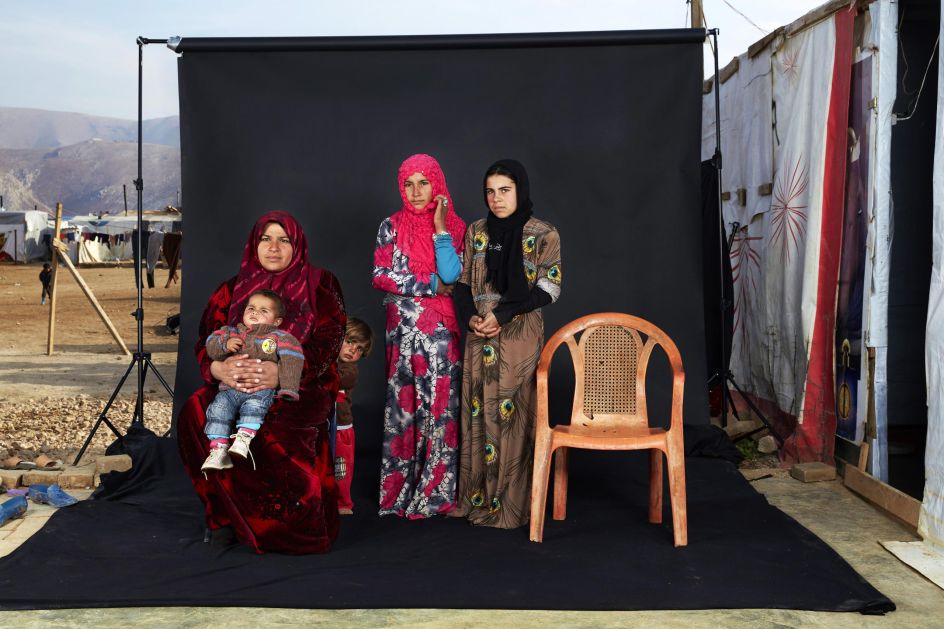 People, third prize singles: Portrait of a Syrian refugee family in a camp in Bekaa Valley, Lebanon. The empty chair in the photograph represents a family member who has either died in the war or whose whereabouts are unknown. Dario Mitidieri.