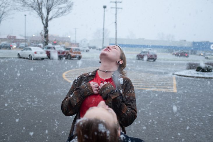 Allie and Regina catching snowflakes after a close friend's funeral. © Mark E. Trent