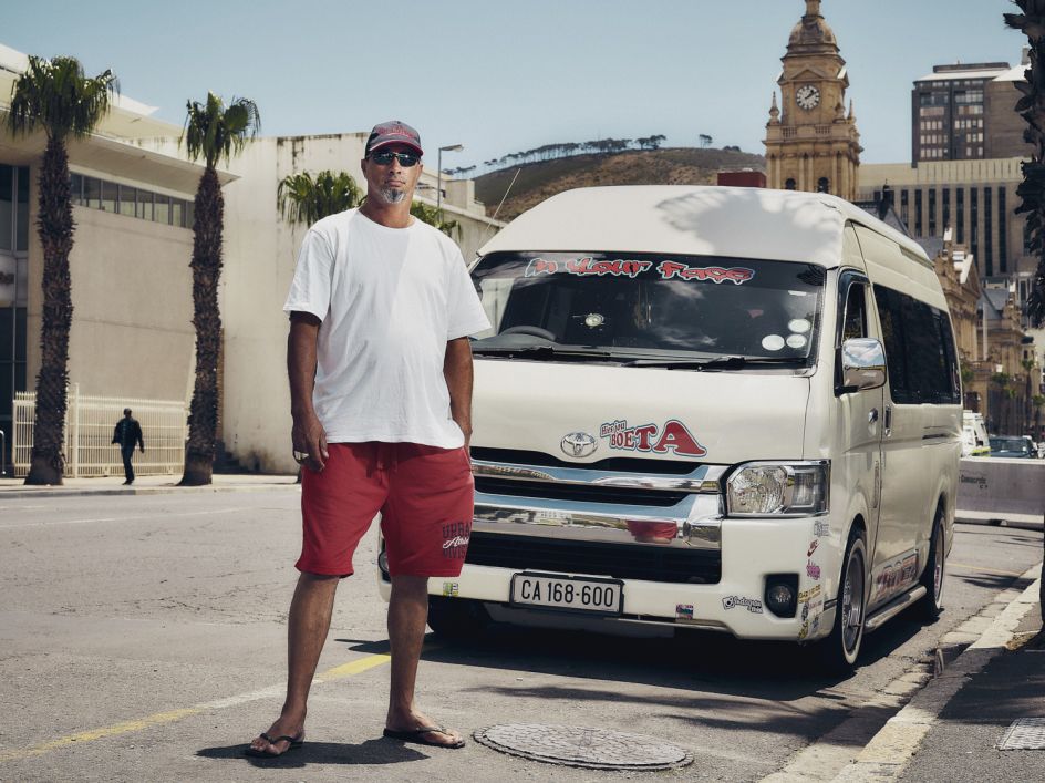 “I enjoy my job very much - have been doing this for 23 years! I love meeting different people every day and business has always been good. Then Uber shows up and I see them picking up all the people that we used to - everyone’s standing outside on their phones, waiting for Uber to arrive. How can they charge such little money? I don’t get it. I’m very much angry towards the drivers - how they drive, how they operate - they just stop in the middle of the road! There’s no way we can work together.  Taxi drivers are selling off their permits and I think it’s going to get worse. But I would never go to Uber. If they kill us off and they take my vehicle I don’t know what I’d do instead.” - Toyer, Cape Town. The Uber Impact © Matthew Joseph