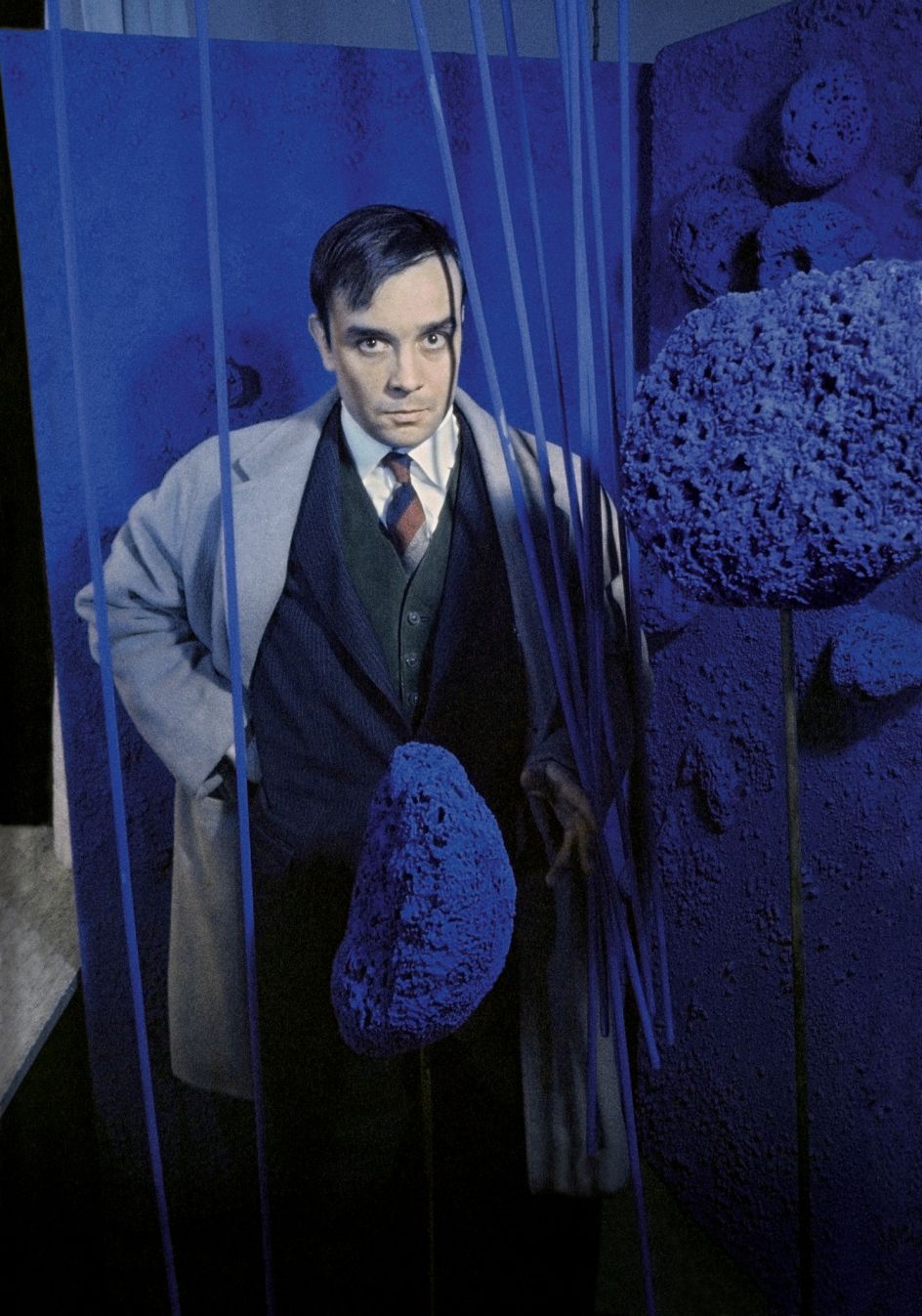 Yves Klein surrounded by his « Sponge Sculptures » during the opening of the exhibition 