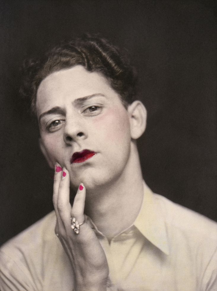 Man in makeup wearing ring. Photograph from a photo booth, with highlights of color. United States, circa 1920. © Sebastian Lifshitz Collection Courtesy of Sebastian Lifshitz and The Photographers’ Gallery