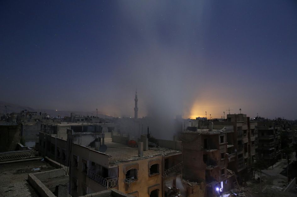 Spot News, first prize stories: Smoke rises from a building following reported shelling by Syrian government forces in Douma, Syria. Sameer Al-Doumy.